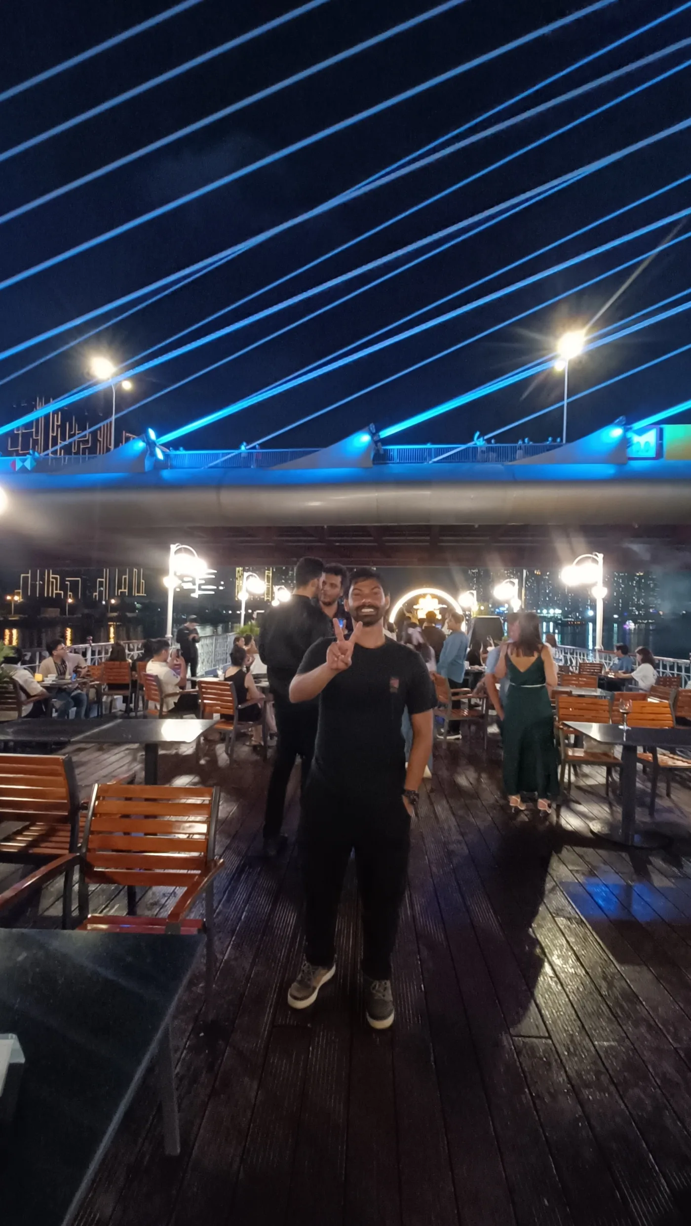 Aniketh aboard a Saigon River dinner cruise beneath blue lights